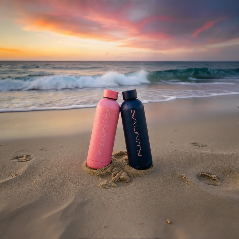 Salinity bottles standing in the sand at sunset